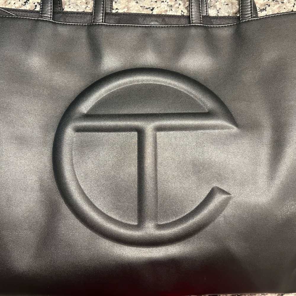 A large Telfar tote bag in new condition with dust bag.